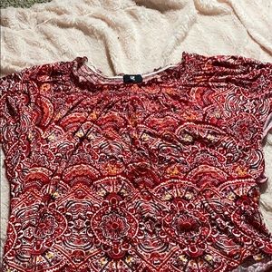 a red patterned off shoulder t shirt